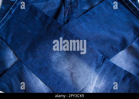folded blue jeans pant pattern texture background Stock Photo