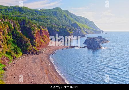 Misty Hills Above a Remote Beach in the Green Gardens in Gros Morne National Park in New Foundland Stock Photo