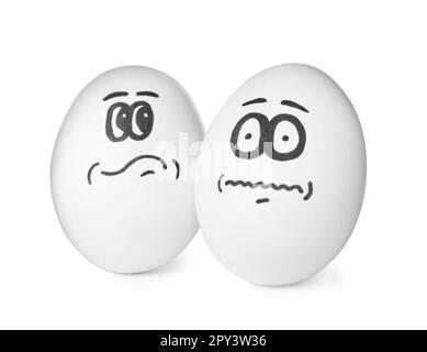 Eggs with drawn thoughtful and frightened faces on white background Stock Photo
