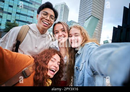 Smiling multi-ethnic university students taking selfie on erasmus Europe. Cheerful young people. Stock Photo