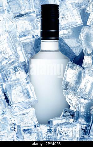 Bottle of vodka and ice cubes, closeup view Stock Photo