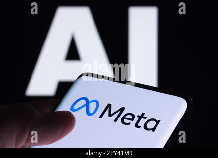 Meta logo seen on smartphone and AI letters on the background. Concept for Meta Facebook Artificial Intelligence. Stafford, UK, May 2, 2023 Stock Photo