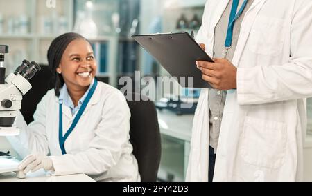 Getting all their lab work done. two scientists working together in a lab. Stock Photo