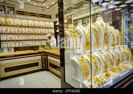Dubai gold souk market window with jewellery, necklaces, dress and luxury accessories. DUBAI, UNITED ARAB EMIRATES - April, 2023 Stock Photo