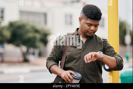 Dont make the mistake of being late. a young businessman checking the time while walking through the city. Stock Photo