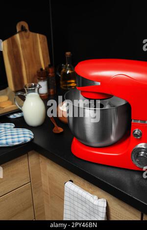 White kitchen machine and stand mixer on a wooden table in a bright design  apartment Stock Photo - Alamy