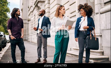 We should give it our all in this meeting. two businesswomen having a discussion while walking through the city together. Stock Photo