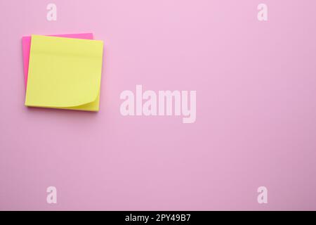 Paper notes on pale pink background, top view. Space for text Stock Photo