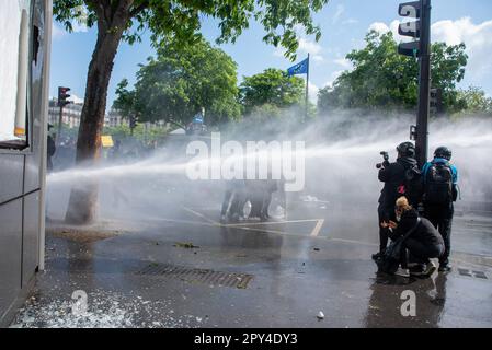 Paris, France. 01st May, 2023. The police deploys water cannon to disperse protesters during the Labor Day demonstration in Paris. Hundreds of thousands of people attended on the Labor Day protest in Paris to demand to stop the very unpopular pension reform. The protest escalated violent in a very short while. The protesters and the police clashed many times during the day. The protesters broke into the shops and light up anything flammable. The police deployed water cannon and tear gas to stop the riot. Credit: SOPA Images Limited/Alamy Live News Stock Photo