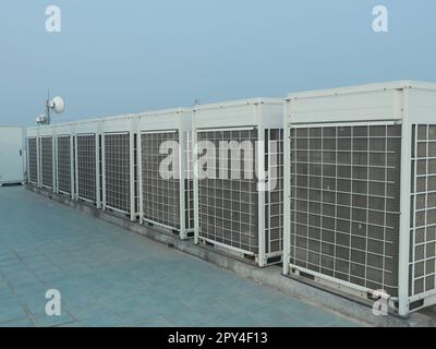 Industrial air conditioner condensers (outside unit) at the Office building rooftop in Dhaka. Stock Photo