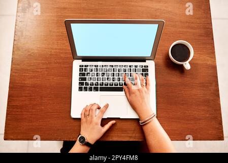 Accessing information with just a few taps. High angle shot of an unrecognisable businesswoman using a laptop in an office. Stock Photo