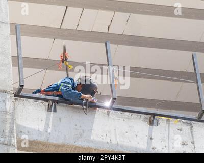 Close up shot of a worker welding in a construction site at Mexico Stock Photo