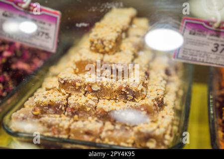 Traditional oriental sweet pastry cookies, nuts, dried fruits, pastilles, marmalade, Turkish desert with sugar, honey and pistachio, in display at a Stock Photo