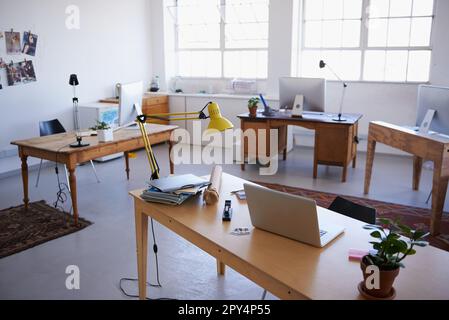 Empty office, startup or laptop on desk in workplace, company or workspace room for business. Background, modern interior design or wooden table Stock Photo