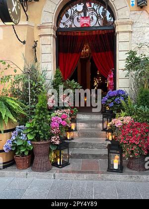 WARSAW, POLAND - JULY 15, 2022: Beautiful plants and lanterns near entrance in restaurant Stock Photo