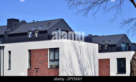 Terraced family homes in newly developed housing estate. The real estate market in the suburbs. New single family houses in a new development area. Stock Photo