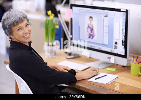 Senior woman at desk, computer screen and smile in portrait, editor at magazine and editing image with software for publication. Professional female Stock Photo