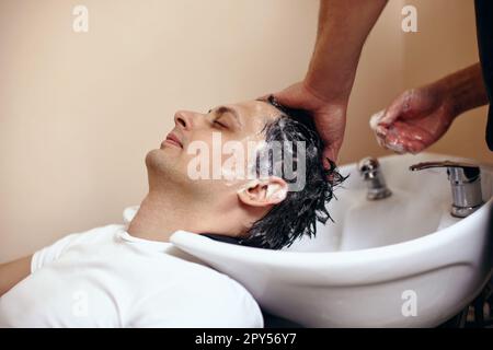 Barber washing hair of caucasian man , close-up Stock Photo