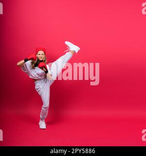 Little girl wearing red boxing gloves, studio shot, sport concept Stock Photo
