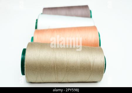 Spools of thread various color on a white background Stock Photo - Alamy