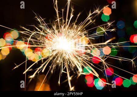 Bengal fire on Christmas tree background Stock Photo