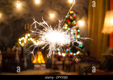Bengal fire on Christmas tree background Stock Photo