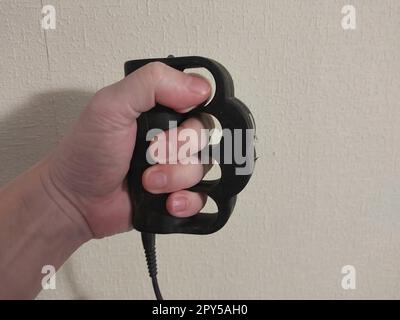 Taser brass knuckles for self-defense and defense Stock Photo