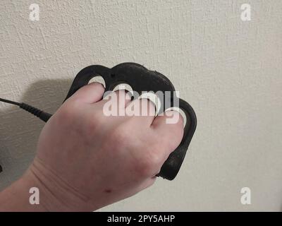 Taser brass knuckles for self-defense and defense Stock Photo