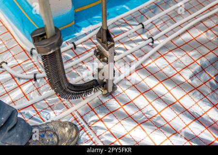 staple tacker gun for underfloor heating pipes Stock Photo