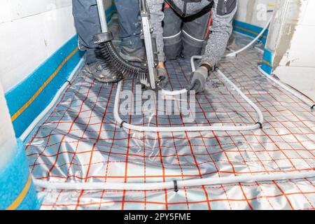 installation of underfloor heating in a new building Stock Photo