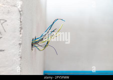 colored wires in the wall, preparation of electrical installation for a new house Stock Photo