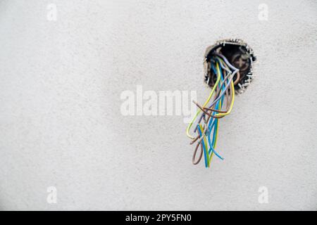 colored wires in the wall, preparation of electrical installation for a new house Stock Photo