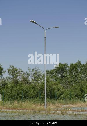 one street pole with two lanterns in nature Stock Photo