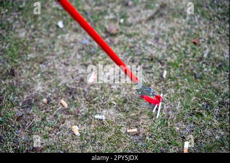 cigarette pick up tool Person with Grabber Reacher picking butts from ground Stock Photo Enjoy comfortable 1 Pik Stik Trash Stik Pick