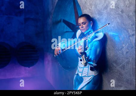 Side view portrait of beautiful fashion woman violinist Stock Photo
