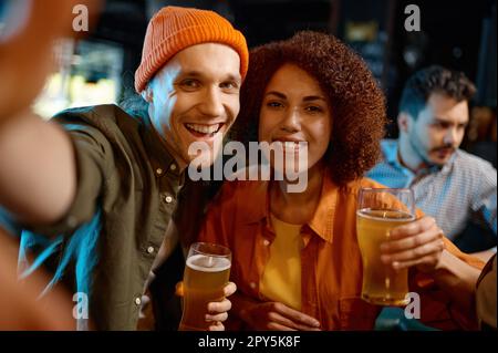 Happy friends taking selfie photo while rest at sports bar Stock Photo