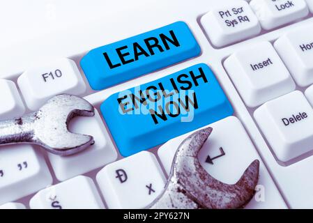 Hand writing sign Learn English Now. Word for gain or acquire knowledge and skill of english language Stock Photo