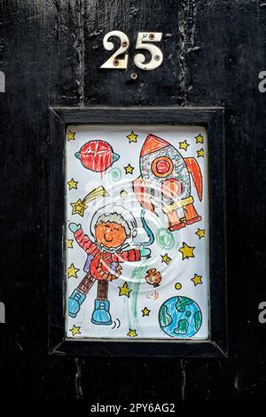 Child's art with drawing feature at the entrance door of a home. England UK Stock Photo