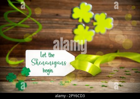 Saint Patrick's Day Decoration, Label, English Text Let The Shenanigans Begin Stock Photo