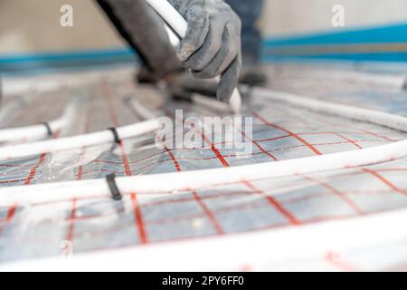 pipes for heating the floor with hot water. close-up detail Stock Photo