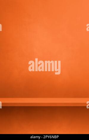 Empty shelf on a neon orange concrete wall. Background template. Vertical mockup Stock Photo