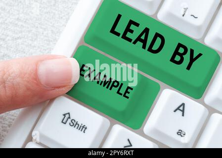 Text caption presenting Lead By Example. Business idea Be a mentor leader follow the rules give examples Coach Stock Photo