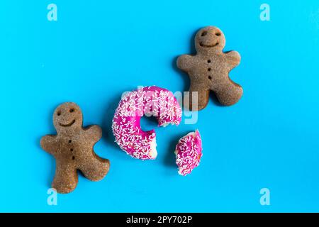 Donut with hazelnuts on blue background, close up Stock Photo