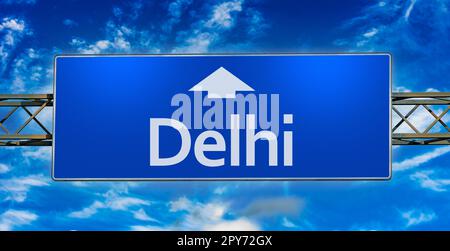 Road sign indicating direction to the city of Delhi Stock Photo