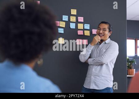 Theres no room for small thinkers here. a team of young businesspeople having a brainstorming session in a modern office. Stock Photo