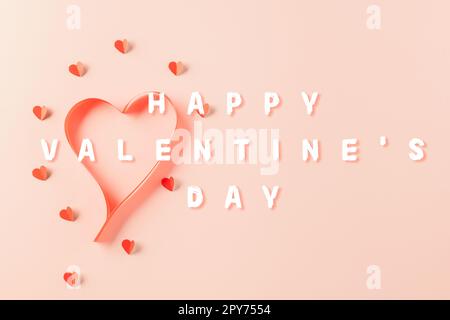 Top view flat lay of Ribbons shaped as heart and paper elements cutting red hearts flying Stock Photo