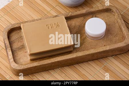 Rectangular brown laundry bar of soap on a wooden background, top view Stock Photo