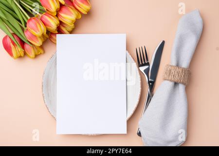 Menu card mockup. Festive table setting with a bouquet of tulips Stock Photo