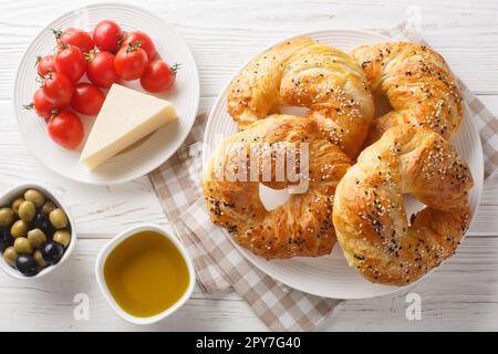 Traditional acma Turkish bread buns Freshly baked homemade pastry closeup on the plate on the table. Horizontal top view from above Stock Photo