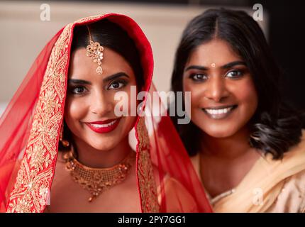 Every bride wants her bestie there on her special day. a young woman getting getting ready for her wedding with her bridesmaid. Stock Photo